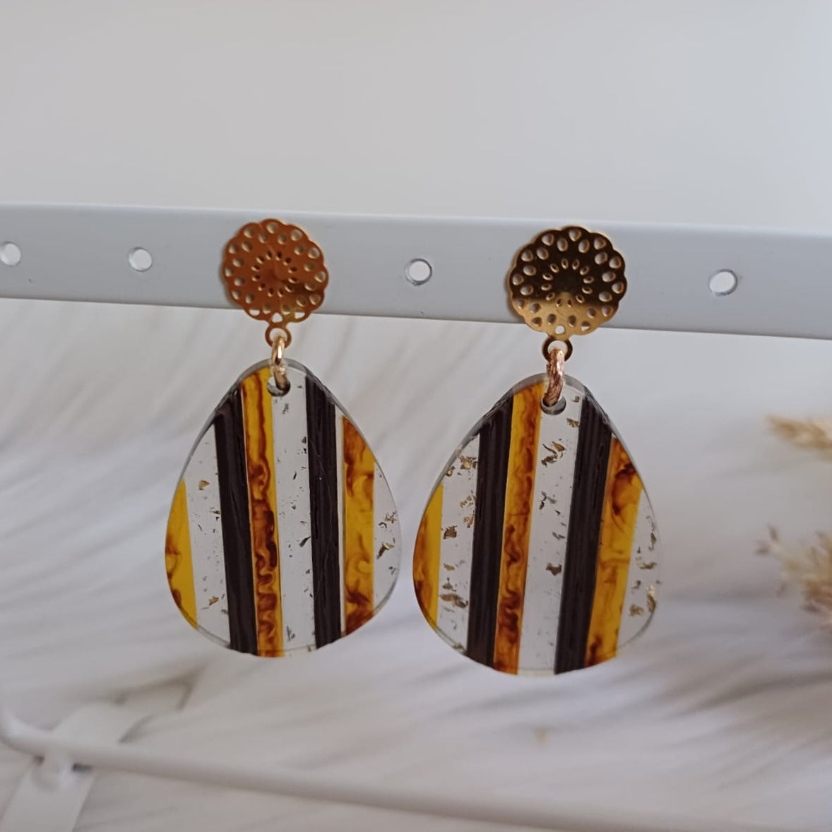 Stud earrings with orange-brown and transparent striped epoxy charms