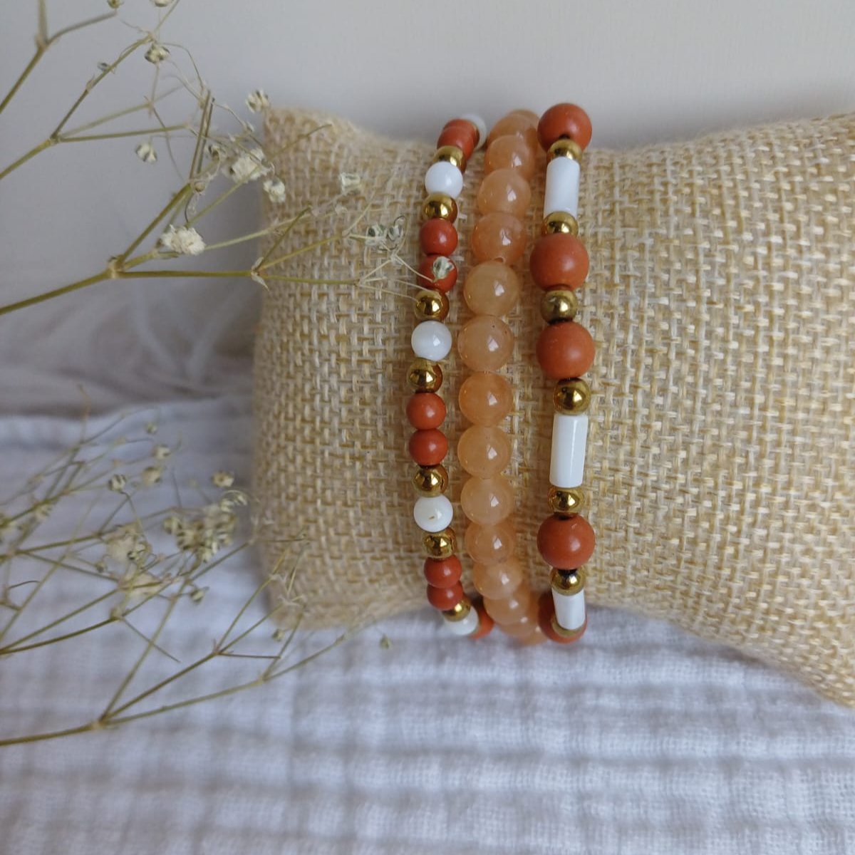 Set of bracelets in orange pink, beige and red